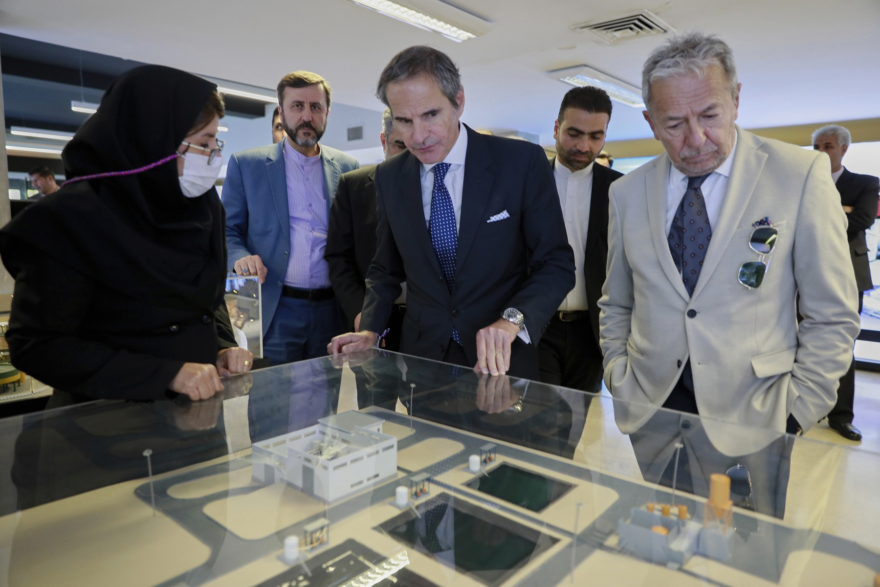 In this photo released by the Atomic Energy Organization of Iran, International Atomic Energy Agency (IAEA) Director General, Rafael Mariano Grossi, center, visits an exhibition of Iran's nuclear achievements, in Tehran, Iran, Thursday, April 17, 2025. (Atomic Energy Organization of Iran via AP)