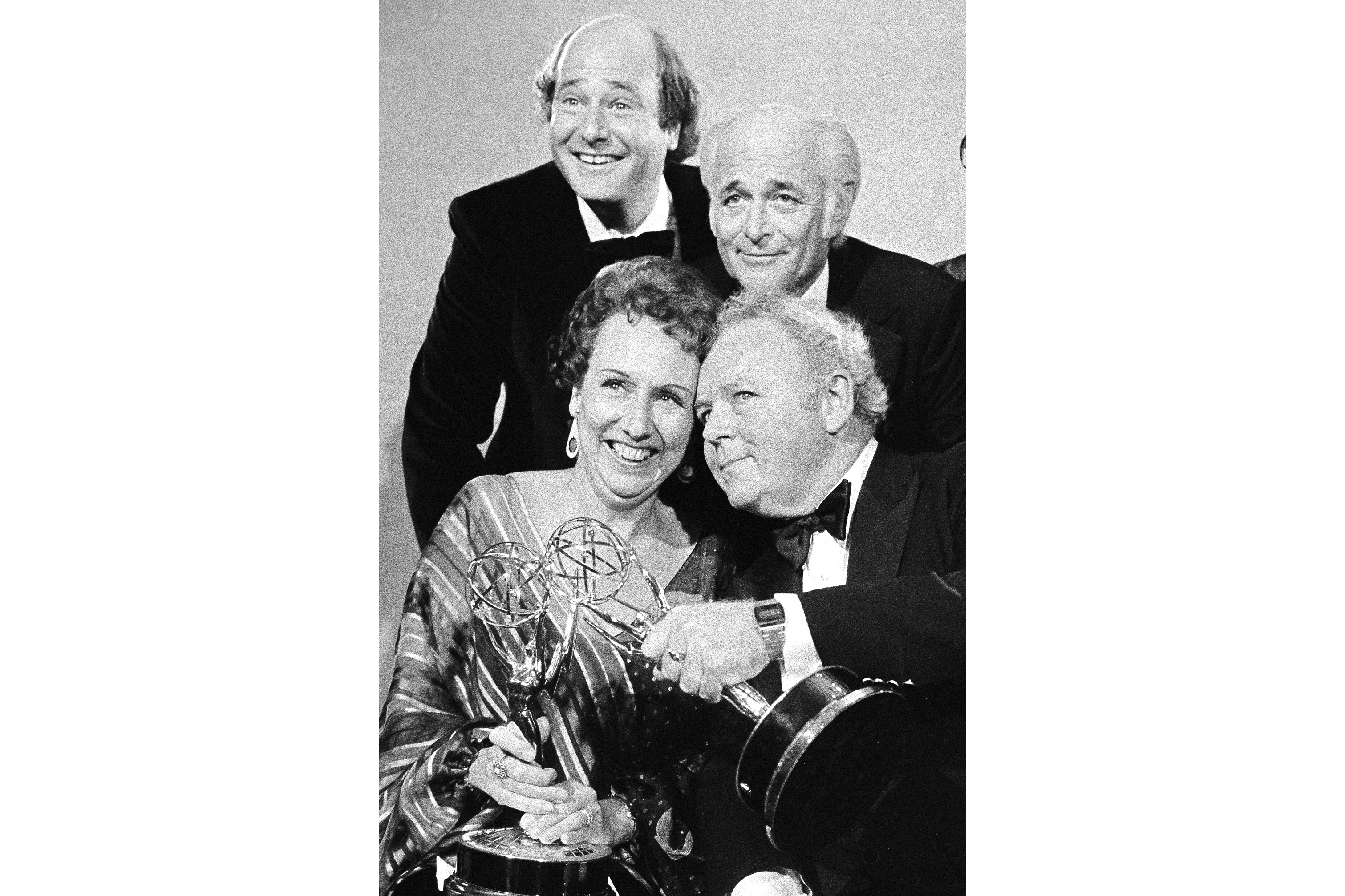 FILE - Actors Jean Stapleton, seated, left, and Carroll O'Connor, seated, right, hold their Emmys for “All in the Family” after receiving them on Sept. 18, 1978, in Los Angeles. At rear, from left to right are Rob Reiner, who won an Emmy for supporting actor in the same series; Norman Lear, producer of the show; and executive producer Mort Lachman. (AP Photo, File)