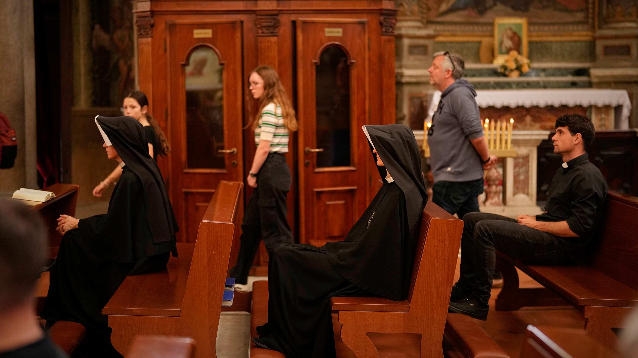 Nuns sit in the Chiesa di Santo Spirito in Sassia, outside Vatican City, Wednesday, April 23, 2025. (AP Photo/Andreea Alexandru)
