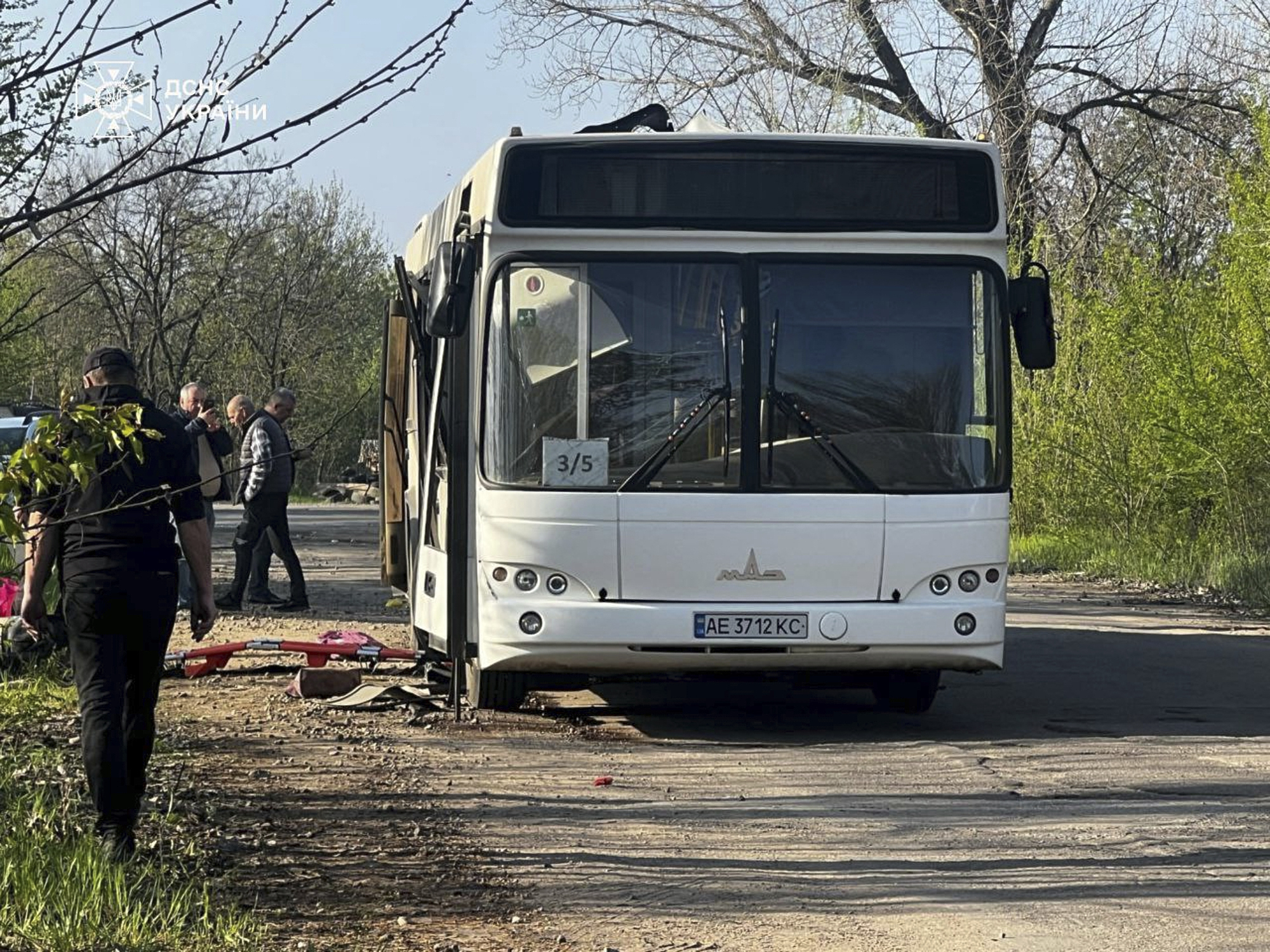 In this photo provided by the Ukrainian Emergency Service, a damaged bus that was hit by the Russian drone in Marhanets, Dnipropetrovsk region, Wednesday, April 23, 2025. (Ukrainian Emergency Service via AP)
